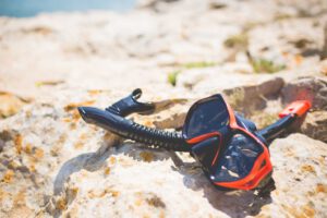 Snorkel and Diving Scuba Mask On a Rock Near The Sea 5